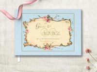 light blue traditional hardcover wedding guest book featuring antique french ephemera frame on the cover with pink floral accent and gold bronze wording personalized with names and wedding date