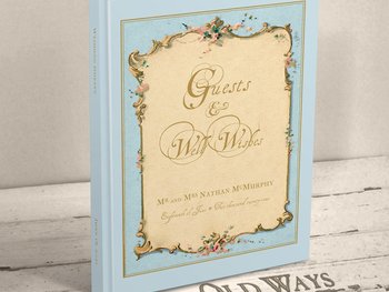traditional hardcover personalized wedding guest book featuring and antique french cottage style frame in blue personalized with names and wedding date